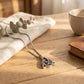 Men's Viking cremation necklace on wooden surface — stainless steel Celtic Trinity ash pendant